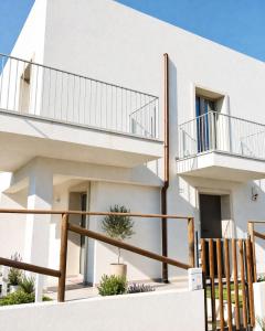 a white building with two balconies on it at 18 Gradi Apartments in Birgi Vecchi