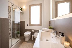 a bathroom with a sink and a toilet and a window at 18 Gradi Apartments in Birgi Vecchi +41 photos