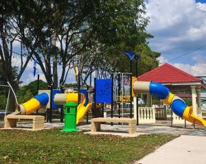 a playground with a slide in a park at Homestay Santai Bertam in Kepala Batas