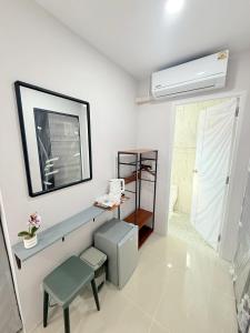 a bathroom with a sink and a air conditioner at Dana Residence in Ko Yao Noi