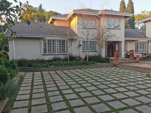 a house with a stone patio in front of it at The Boho Suite in Benoni