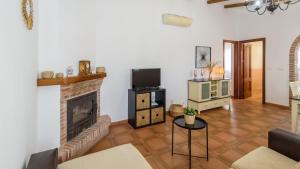a living room with a fireplace and a tv at Elsa Torrox by Ruralidays in Torrox