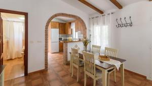 a kitchen and dining room with a table and chairs at Elsa Torrox by Ruralidays in Torrox