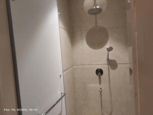 a shower in a bathroom with a glass door at Shagun Hotel & Resorts in Khandwa