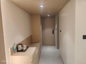 a corridor of a room with a counter and a hallway at Shagun Hotel & Resorts in Khandwa