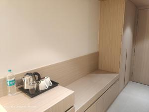 a room with a cupboard with a tea set on it at Shagun Hotel & Resorts in Khandwa