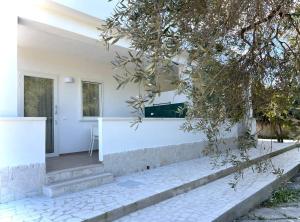a white house with stairs leading to the front door at Residenza Villa Terry in Vieste