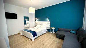 a blue bedroom with a bed and a couch at Residenza Villa Terry in Vieste +71 photos