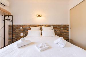 a bedroom with a white bed with towels on it at "La Sorra" Résidence en Bord de mer in Saint-Cyprien