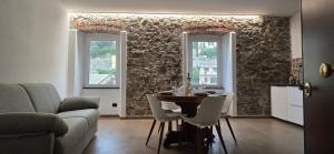 a living room with a table and two windows at Cinque Terre Homes by Bluchalet in Riomaggiore