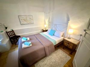 a bedroom with a large bed with towels on it at La Casa Turquesa in Frigiliana +207 photos