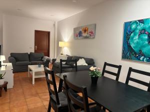a living room with a table and a couch at Sanmao Vibbecanarias Playa del hombre Telde in Playa del Hombre