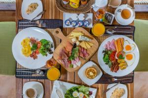 a wooden table with plates of breakfast food on it at High Season Pool Villa & Spa in Ko Kood +71 photos