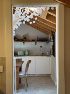 a kitchen with a table and a kitchen with a ceiling at Lakeview Jonny house on the roofs in Lezzeno