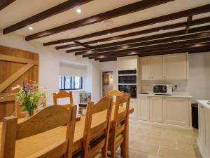 a kitchen and dining room with a table and chairs at Bridge Cottage in Bridport