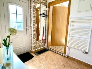 a hallway with a mirror next to a door at Ferienwohnung in der Seestraße in Sassnitz +7 photos