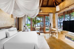 a bedroom with a white bed and a television at High Season Pool Villa & Spa in Ko Kood