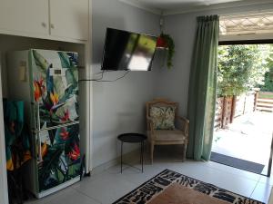 a living room with a tv and a chair at Milkwood Haven in Pennington