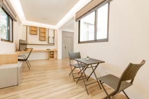 a kitchen and living room with a table and chairs at 杉杉行旅 Araucaria Residence in Huxi