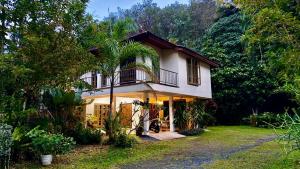 a house with a palm tree in front of it at Natures relax in Kamala Beach