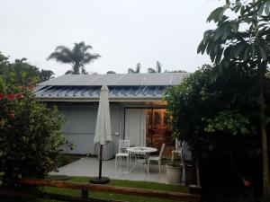 a house with a patio with a table and an umbrella at Milkwood Haven in Pennington