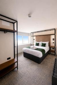 a bedroom with a large bed and a projection screen at Glass Tower - By Central Beach Leisure in Blackpool
