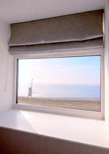 a window with a view of the ocean at Glass Tower - By Central Beach Leisure in Blackpool