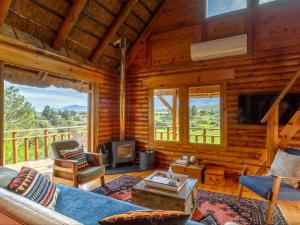 a living room with a couch and a fireplace at Mountain Cabin private hot tub and swimming pool in Wolseley
