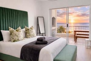 a bedroom with a large bed with a view of the ocean at Sunset View 23 in Langstrand