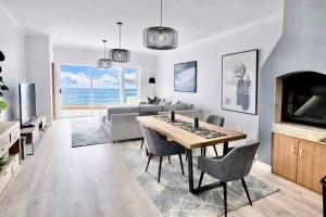 a living room with a table and a couch at Sunset View 23 in Langstrand +13 photos