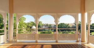 a balcony with arched windows and a view of a park at Gateway Kandla Gandhidham in Gandhidham