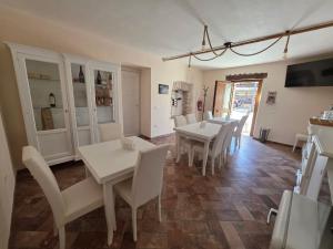 a dining room with white tables and white chairs at Bed&Wine Terrae Tiferni in Gioia Sannitica