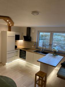 a kitchen with a white refrigerator and a table at Stübchen Nr 37 in Inzigkofen