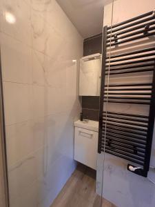 a bathroom with a glass shower and a toilet at La maison penchée in Rosny-sous-Bois +46 photos