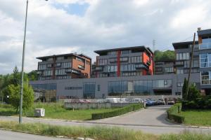 a group of buildings with cars parked in a parking lot at Zozo's Apartment in Sarajevo