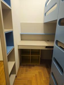 a small closet with a white cabinet and wooden floor at Zozo's Apartment in Sarajevo