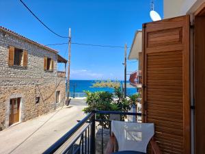 a balcony with a view of the ocean at Avra Apartments in Leonidio