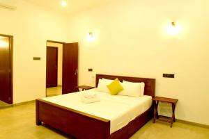 a bedroom with a large bed in a room at Abey Villa Madiha Beach Surf Stay in Matara