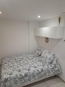 a white bedroom with a bed with a white cabinet at La Parenthèse Lémantine - Studio 3 in Neuvecelle