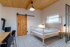 a bedroom with a bed and a table and chairs at gardenSTUDIO in Děčín