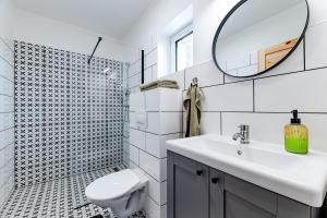 a white bathroom with a sink and a mirror at gardenSTUDIO in Děčín +4 photos