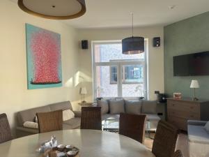 a living room with a couch and a table at Villa Le Roy in Blankenberge