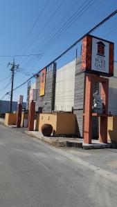 a building with a sign on the side of a street at ホテルピュアゲート in Isesaki