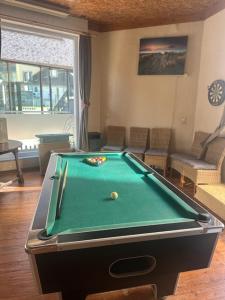 a pool table in a living room with afits at Villa Le Roy in Blankenberge +17 photos