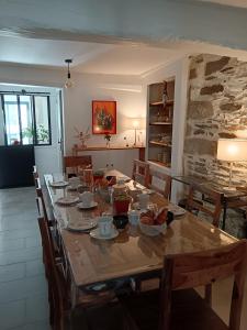 a dining room with a long table with chairs at la demeure des songes in Josselin