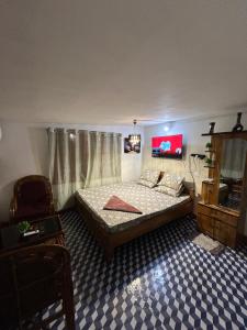 a bedroom with a bed and a chair in a room at Luna leaf Homestay in Guwahati