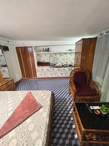 a bedroom with a bed and a chair at Luna leaf Homestay in Guwahati +4 photos