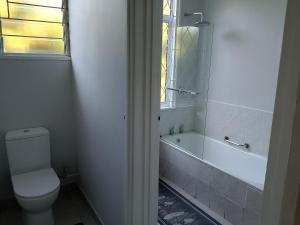 a bathroom with a toilet and a tub and a window at Milkwood Haven in Pennington +14 photos