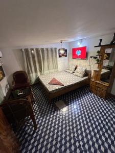 a bedroom with a bed and a blue and white floor at Luna leaf Homestay in Guwahati