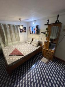 a bedroom with a bed and a mirror in it at Luna leaf Homestay in Guwahati